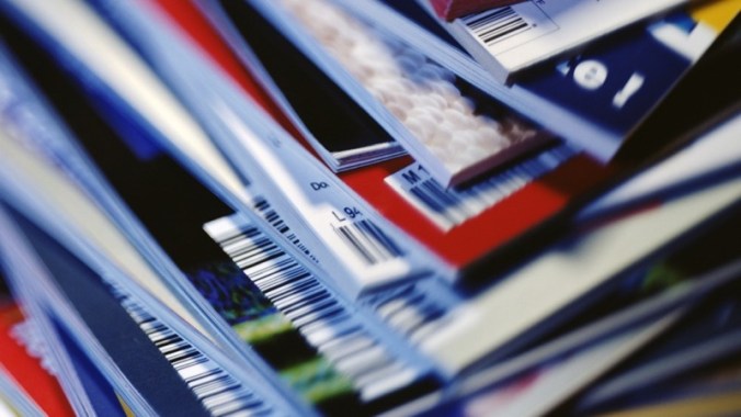 Disorderly stack of magazines, extreme close-up on corners with barcodes, full frame